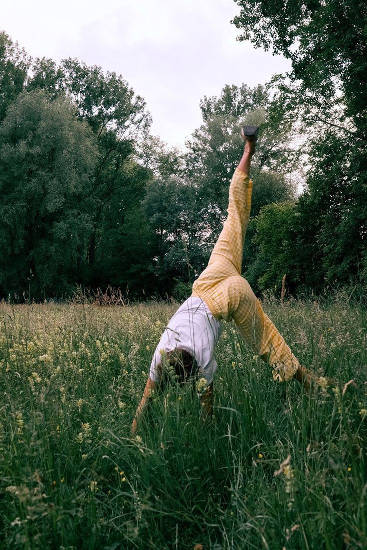 Woman doing a cartwheel in a meadow